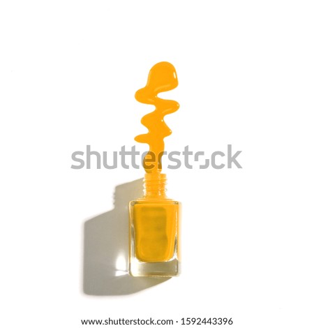 Nail polish leaked from the bottle on white background.