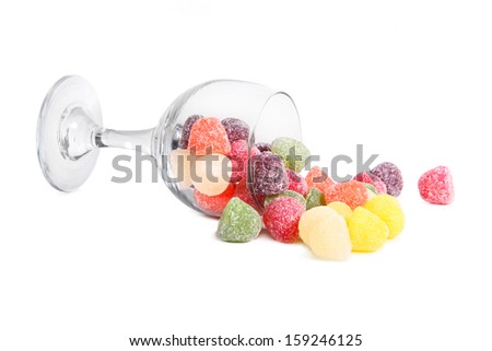 fruit gums spilling out of a glass