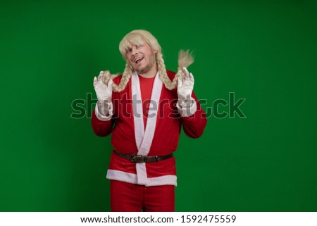 Emotional Santa Claus with long braid hairstyle grimaces and poses on a green chrome background
