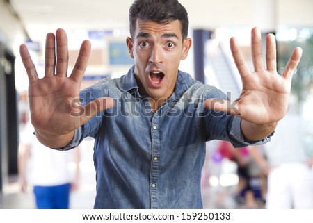 young man stop gesture in a shopping center