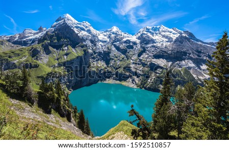 Panorama view of Oeschinensee (Oeschinen lake) on Bernese Oberland Kandersteg in the Oeschinen valley on a sunny summer day, Canton of Bern, Switzerland Royalty-Free Stock Photo #1592510857
