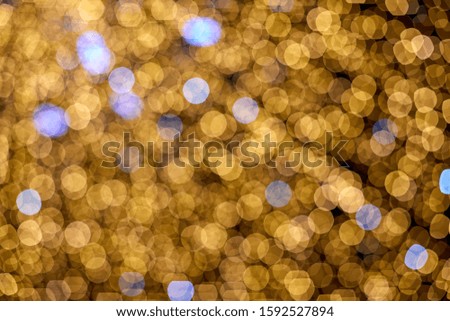 Golden sparkles bokeh on dark background.Christmas light background. Holiday glowing backdrop. Defocused Background With Blinking Stars. Blurred Bokeh.