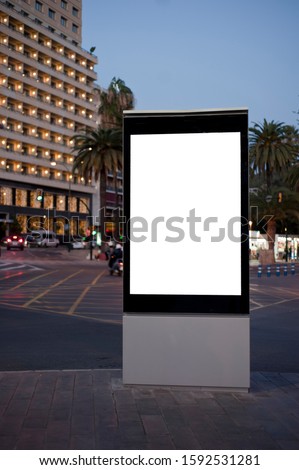 Blank electronic advertising poster with blank space screen for your text message or promotional content, clear banner in urban setting, empty poster at a bus stop, public information billboard
