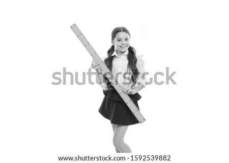Education and school concept. School student learning geometry. Kid school uniform isolated white. STEM concept. Draw geometric figures. Pupil cute girl with big ruler. Favorite school subject.