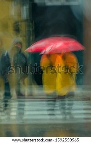 FEBRUARY 2, 2019 - LOS ANGELES, CA, USA - abstract person holds umbrella in rain storm in downtown Los Angeles giving a impressionistic feeling