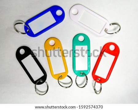 A colorful key chain with a writable center