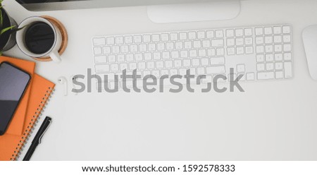 Overhead shot of modern office room with office supplies and copy space on white wooden table 