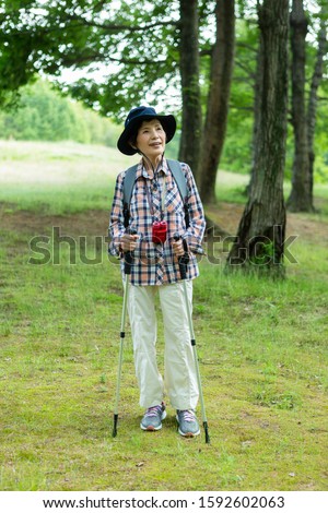 Senior woman taking a walk in the mountains