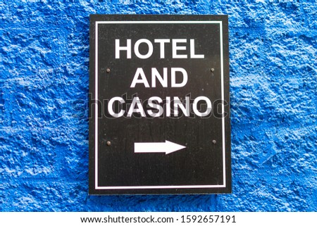 Hotel Casino sign on the wall directing customers to the entrance to logging and gambling facility.