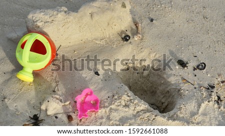 Image of kid's toy at a beach sand