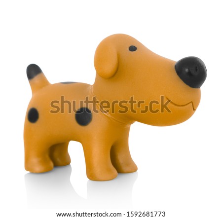 Stylish dog plastic toy. Isolated on white background with shadow reflection. With clipping path. Brown doggy with black stains. 