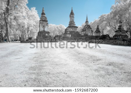 Ruined ancient Buddhist temple and pagoda in Srisatchanalai historical park, Sukhothai, Thailand in infrared photography