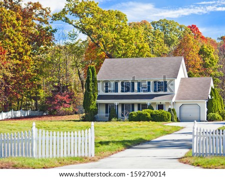 Typical New England colonial style house in the fall  Royalty-Free Stock Photo #159270014