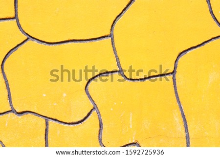 Yellow wall with free geometric decoration.