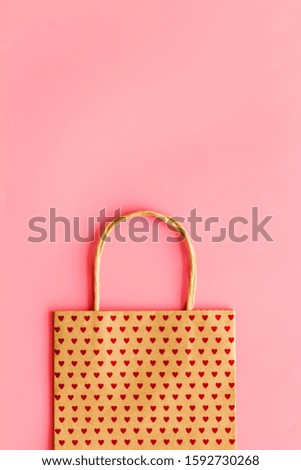 Shopping concept. Paper bag on pink background top-down copy space