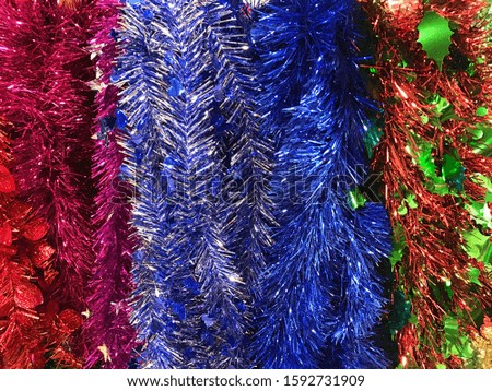 Colorful christmas tinsel and sparkling garland trimming, background and texture