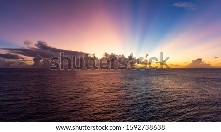 Dramatic View of a cloudscape during a dark and colorful sunset. Taken in the Tropics of Caribbean Sea in Barbados.