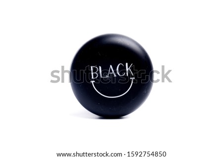 A picture of black word with smile at earphone cover on white background.