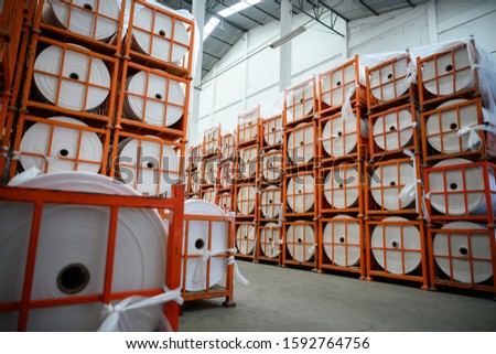 Stock of plastic film rolls to produce Shopping bags in warehouses. In the concept of Save the world and the environment