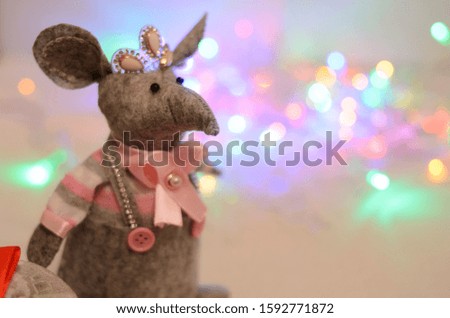 Christmas rat Symbol of the new year 2020. Year of the rat. Chinese New Year 2020. Christmas toys, bokeh. Rat on the background of Christmas decorations.