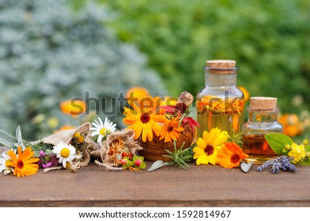 homemade marigold oil and marigold flowers