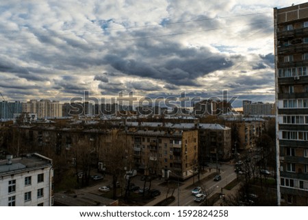 City landscape with gloomy sky and thick clouds.