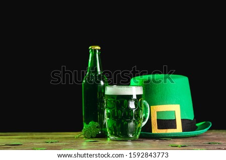 Green beer and Leprechaun's hat on table. St. Patrick's Day celebration