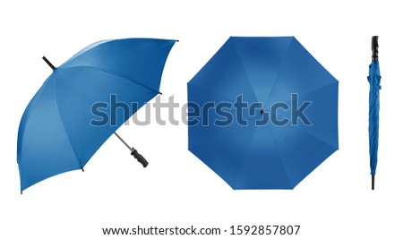 A set of classic umbrella or parasol with long straight handle in classic blue colour. Different angel shoots Isolated on white background. It is designed to protect a person against rain or sunlight Royalty-Free Stock Photo #1592857807