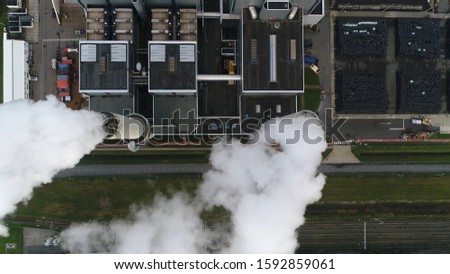 Aerial satellite view of coal fired power station is a thermal plant which burns a fossil fuel to produce electricity by converting heat of combustion into mechanical energy Royalty-Free Stock Photo #1592859061