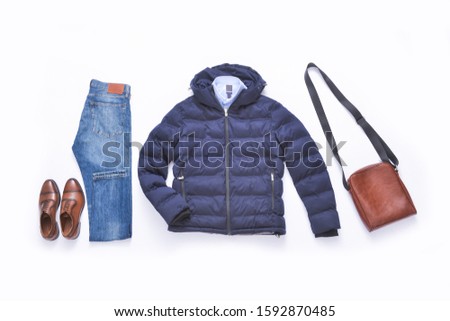 Blue warm jacket with blue shirts with brown handbag ,blue jeans, leather brown shoes on white background
