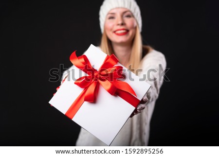 stock photo Woman holding white present box with red ribbon