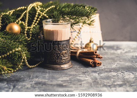 Glass of hot chocolate in winter decorations on the rustic background. Selective focus. Shallow depth of field.