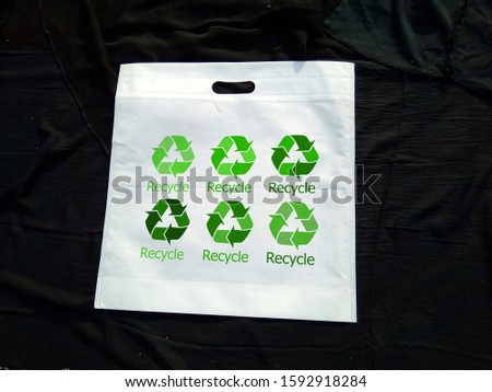 White Color Non woven white fabric eco bag with recycle slogans on black background