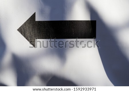 Direction arrow on a white tent