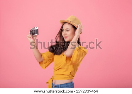 Young asian women yellow shirts and jeans happy and enjoying camera on pink background.