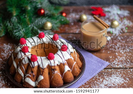 Beautiful festive cupcake decorated with whipped squirrels and raspberry jelly. On a brown, wooden background. New Year's and Christmas. Copy space.