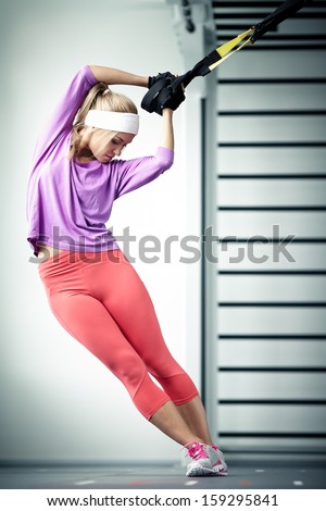 Young woman streching muscles functional training Royalty-Free Stock Photo #159295841