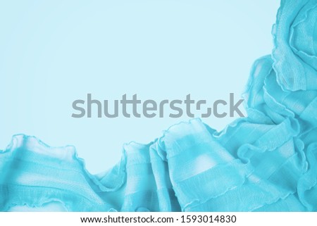 Blue background, lace fabric. Copy space. Flat lay, top view