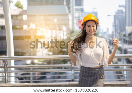 Portrait of a female civil engineering in safety hat ,helmet on outdoor building background