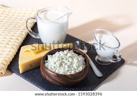 Food, source of calcium, magnesium, protein, fats, carbohydrates, balanced diet. Dairy products on the table: cottage cheese, sour cream, milk, cheese, contain casein, albumin, globulin, free lactose Royalty-Free Stock Photo #1593028396