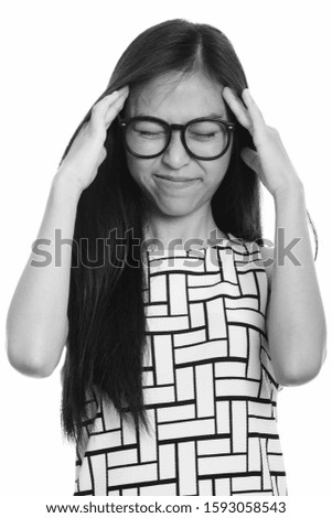 Close up of young Asian teenage nerd girl having headache