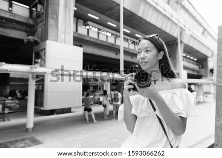 Young beautiful tourist woman exploring the city of Bangkok