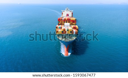 Aerial infront of cargo ship carrying container and running for export  goods  from  cargo yard port to custom ocean concept freight shipping by ship .