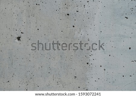 Background image of a concrete wall covered in white paint. Concrete slab texture with small bumps. Graphic resources abstract textured background. Concrete surface photography shot close.
