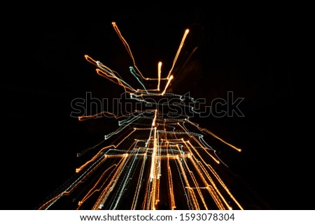 Abstract image with colorful light trails forming an interesting shape, created by light painting photography technique, modern and digital looking wallpaper