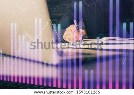Double exposure of businessman with laptop and stock market forex chart.