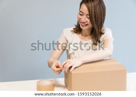 japanese woman unbox cardboard in the room