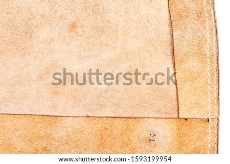 Piece of brown leather isolated on white background. Back side.