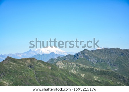 Amazing view to muntain Elbrus from the Tobavarchkhili lake in Samegrelo mountains. Beautiful green nature and summer in Georgia.  Royalty-Free Stock Photo #1593215176