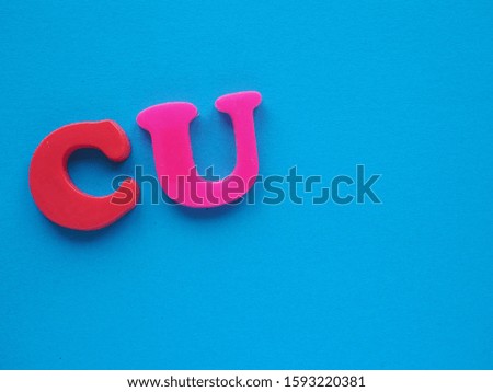 Letters C and U for message See You, on turquoise blue solid background with blank empty room space for text